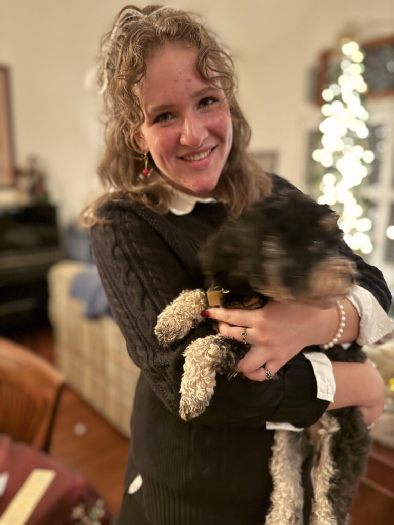 Zoe Byron holding her dog 