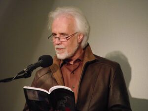Dane Cervine reading at microphone